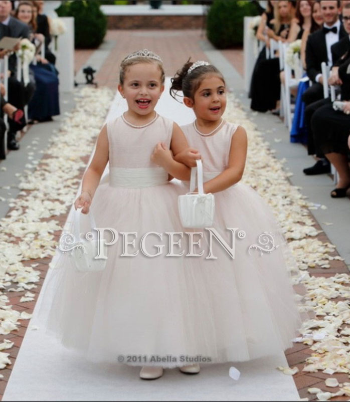 This bride chose various shades of ballet pink and ivory tulle flower girl dresses