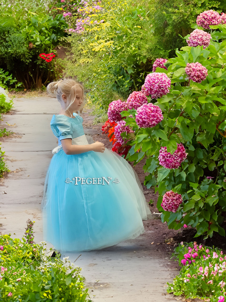 Sister coordinating flower girl dresses in blue and aqua
