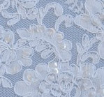 White beaded aloncon - shown on blue fabric