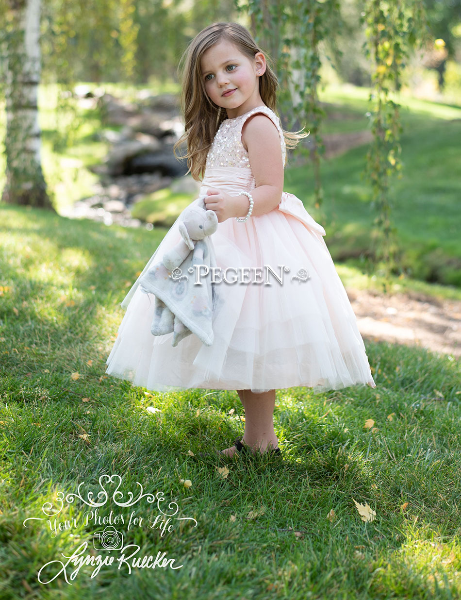 Pink sequinned tulle flower girl dress with handmade flower