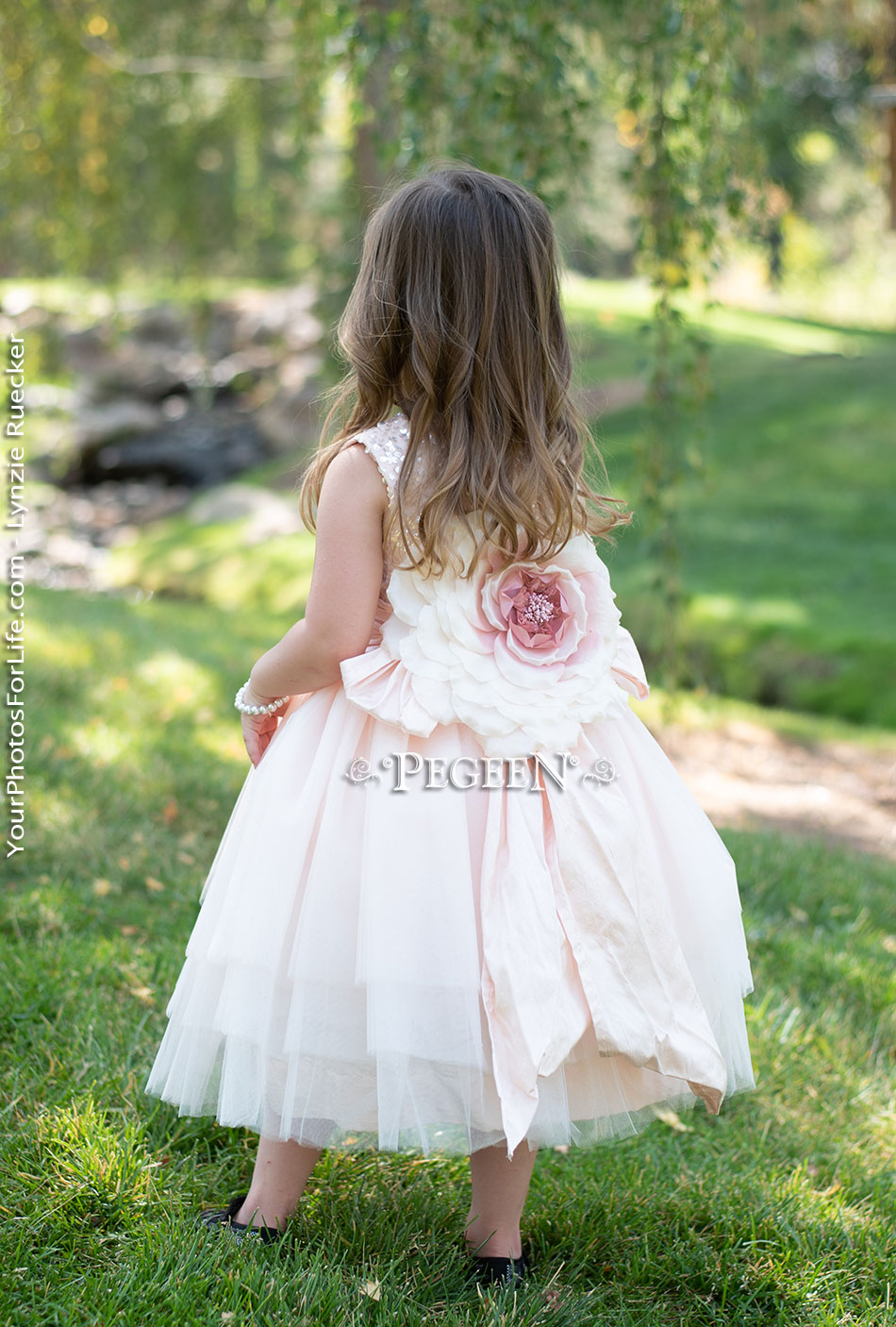 Pink sequinned tulle flower girl dress with handmade flower