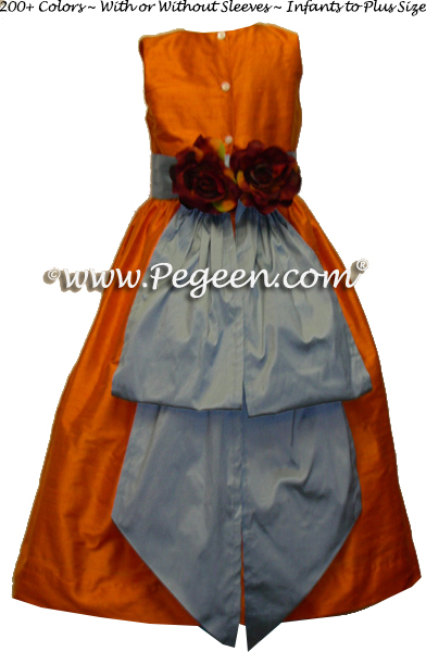 Powder blue and tangerine silk flower girl dresses at beach wedding