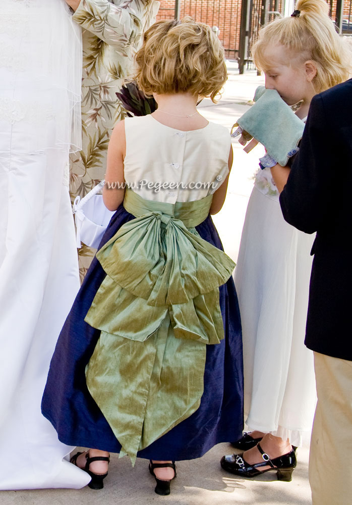 Flower girl dress in navy blue and ivory and a sage green sash